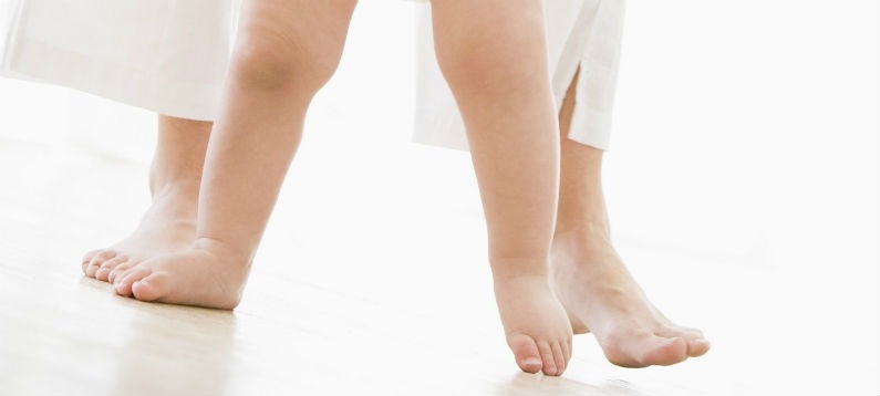 Baby and mom walking barefoot on heated floor